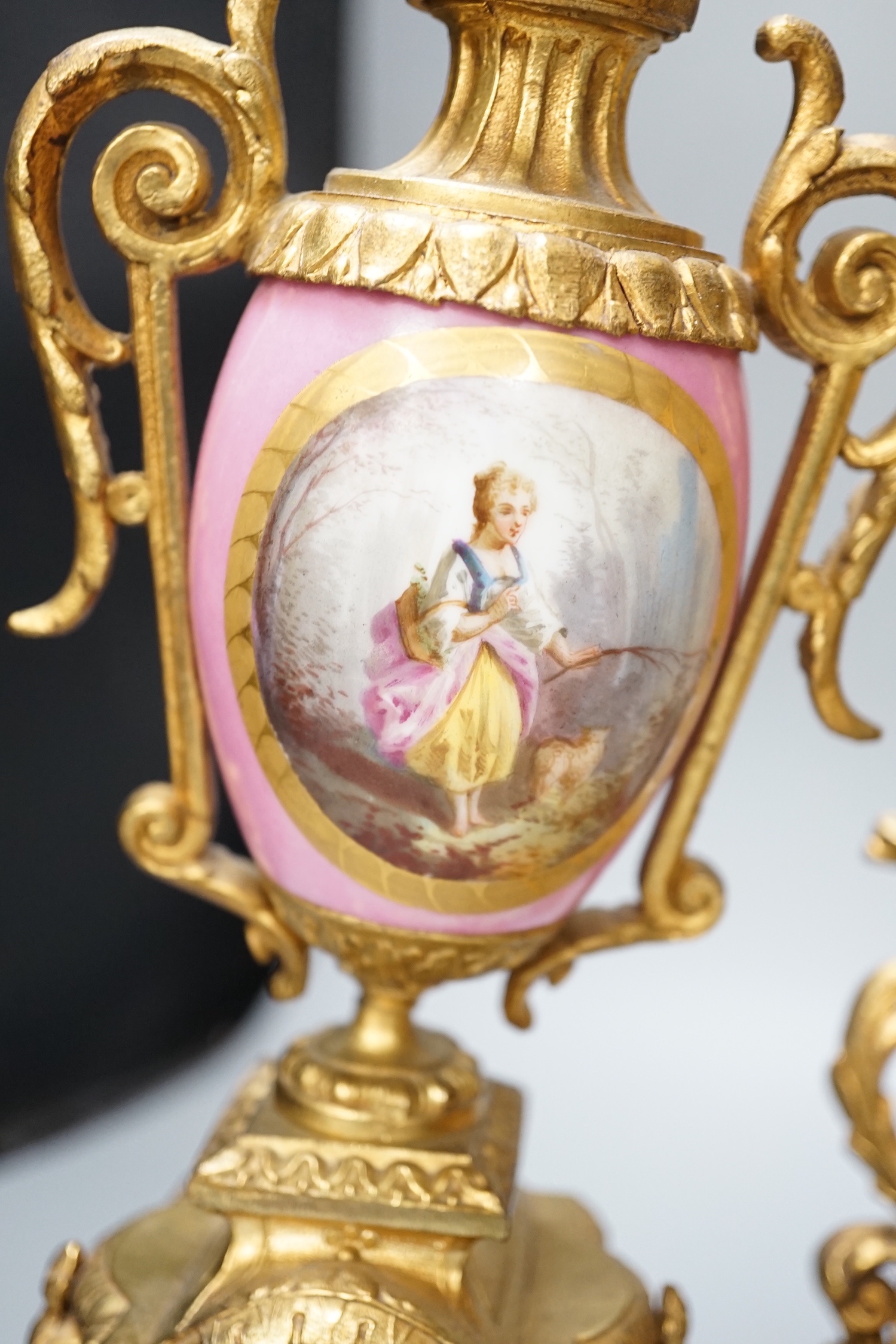 A French gilt metal and porcelain clock garniture. 36.5cm